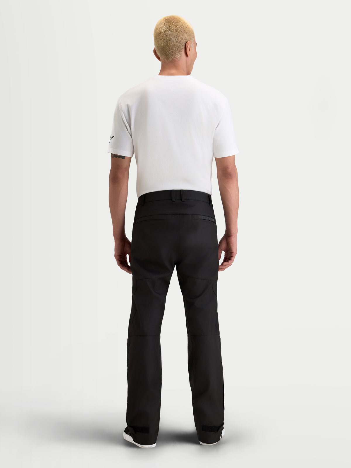 Alpinestars C-1 Waterproof Pants, men's urban contemporary motorcycle riding pants in black, rear view on a model wearing a white t-shirt and waterproof textile gear