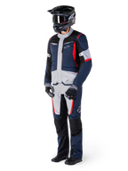 Alpinestars St-1 Waterproof Pants, Adventure Touring Pants, Dark Blue, Black, and Bright Red, worn with a matching touring jacket, black helmet, gloves, and boots, featuring light grey panels, red accents, and Alpinestars branding, designed for all-weather riding.