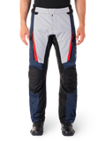 Alpinestars ST-1 Waterproof Pants, Motorcycle Touring Pants, Dark Blue and Light Gray with Bright Red Accents, Black Reinforced Knee Panels, Front View Worn with Black Boots, Waterproof Adventure Touring Gear