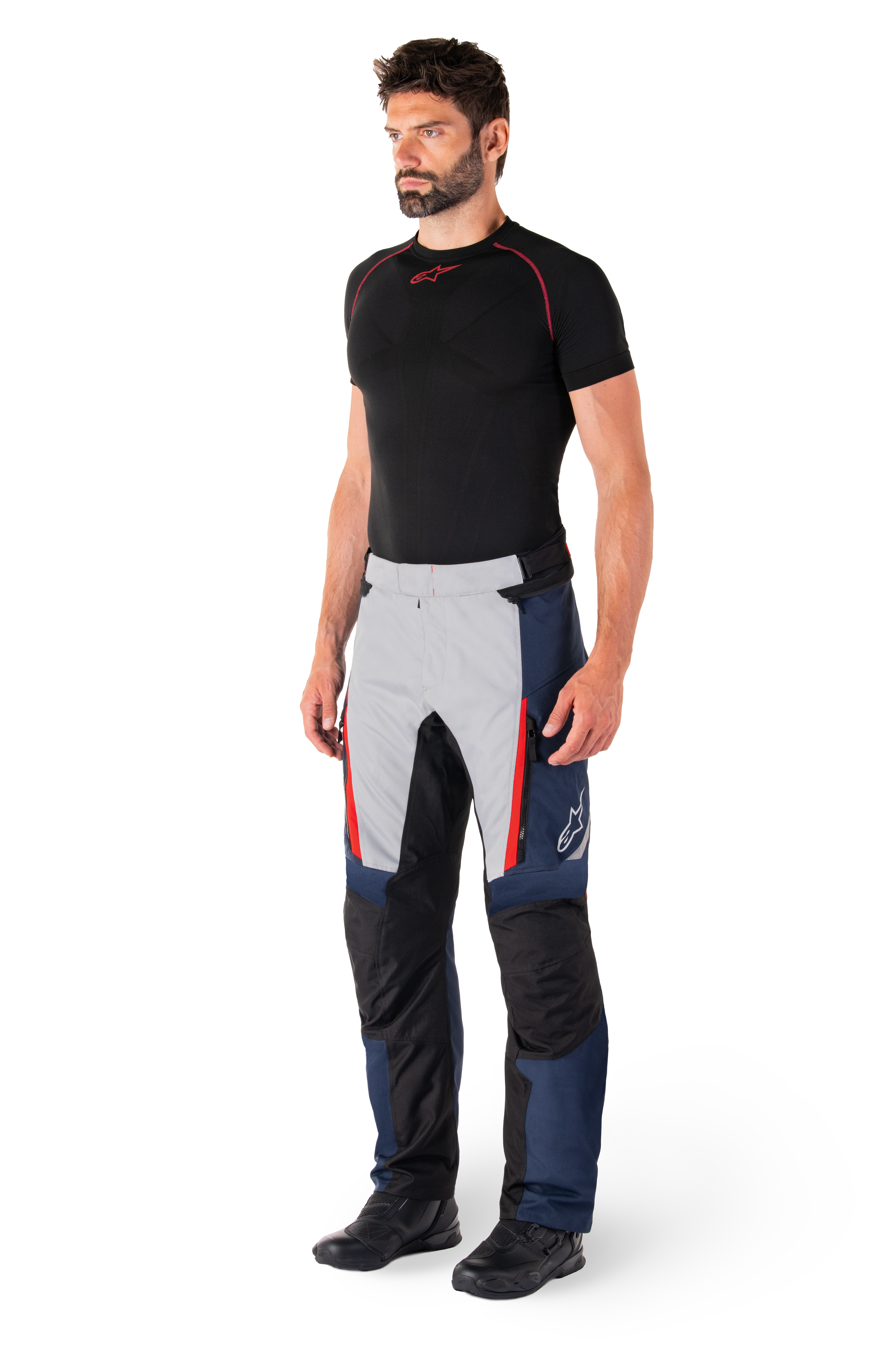 Alpinestars St-1 Waterproof Pants, Motorcycle Touring Pants, Dark Blue Black and Bright Red, worn by model with black base layer and black boots, features zippered pockets and Alpinestars logo on the leg