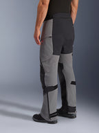 Alpinestars Andes Pro Drystar® XF Pants, Adventure Motorcycle Pants, Dark Gray and Black, rear three-quarter view, featuring textile construction with black reinforced seat and inner leg panels, zippered lower legs, and adjustable tabs.