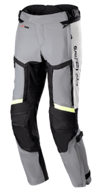 Alpinestars Bogota Pro Drystar 4 Seasons Pants, Regular fit motorcycle touring pants, Ice Gray and Dark Gray with Yellow Fluo reflective strips, featuring large thigh ventilation panels, accordion stretch on knees, and adjustable waist straps, adventure riding gear