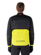 Alpinestars Mootant Waterproof Parka, Motorcycle Jacket, Lime Punch and Black, back view featuring black mesh upper for ventilation and lime lower section with MO.ST.EQ. logo, worn with black pants and gloves