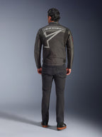 Alpinestars Axton Jacket, Motorcycle Jacket, Black Anthracite Red Tangerine, back view showing large grey Alpinestars logo and star graphic, accordion shoulder panels, worn with black pants and casual black shoes.