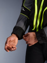 Alpinestars Unite Jacket, Urban Motorcycle Jacket, Black and Asphalt with neon yellow accents, close-up of hands adjusting the elasticated sleeve cuff, minimalist streetwear-inspired protective gear