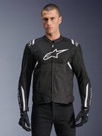 Alpinestars T-SPS Air V2 Jacket, Textile Motorcycle Jacket, Black with White Accents, large white chest logo, perforated mesh design for ventilation, worn with black pants and gloves