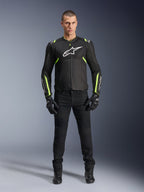 Alpinestars T-Sps Air V2 Jacket, Black and Yellow Fluo, textile motorcycle jacket with mesh paneling, worn by male model with black pants and gloves, featuring white Alpinestars logo on chest, urban sport riding gear