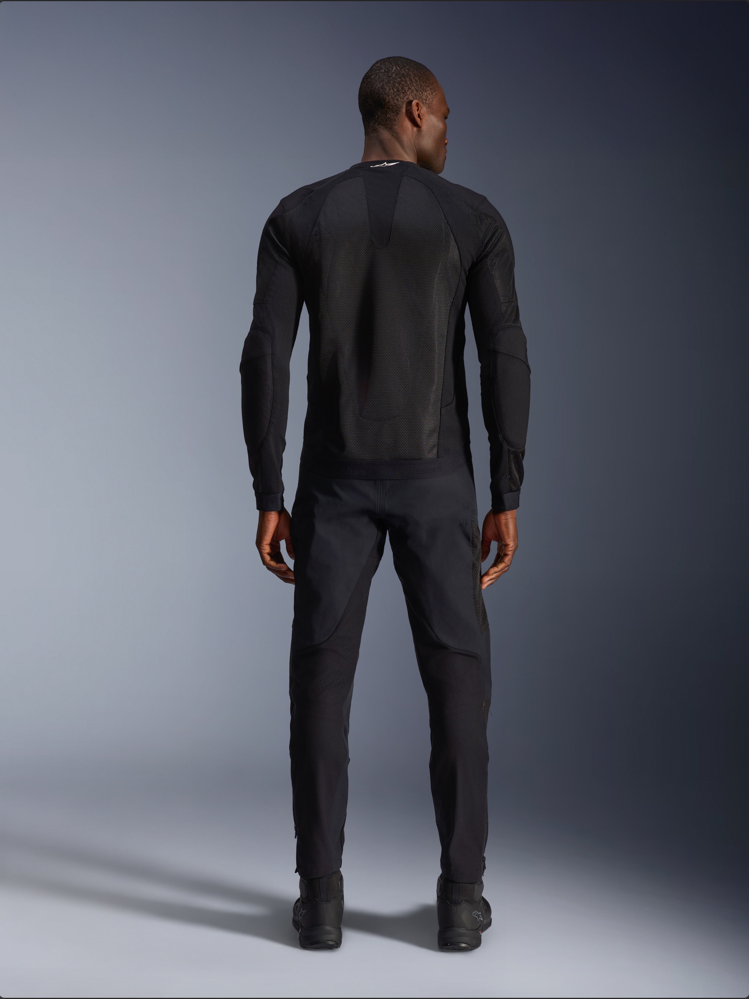 Alpinestars Troop-Air Jacket in Black Black, rear view showing technical mesh back panel and ventilated construction, paired with matching black motorcycle pants and boots
