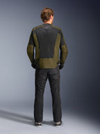 Rear view of a rider wearing the Alpinestars C-1 Air Jacket in Khaki and Black, featuring a large tech mesh back panel for ventilation, paired with black motorcycle pants, urban contemporary road riding gear.