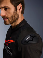 Alpinestars SMX Air Jacket, Black and Red, close-up detail of the DFS Lite shoulder protector with star logo, worn by a man with a beard, textile racing and sport motorcycle jacket.