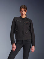 Alpinestars Woman Stella Grace Jacket, Urban Motorcycle Jacket, Black, front view, featuring multiple zippered pockets and a snap collar, worn with black jeans, modern lifestyle-inspired protective gear for women