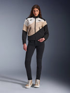 Alpinestars Woman Stella Moshell Jacket, urban motorcycle jacket featuring an asymmetrical Black, Sand, and Off White color-blocked design, worn with black slim-fit pants and tan high-top sneakers, modern streetwear aesthetic for riders.