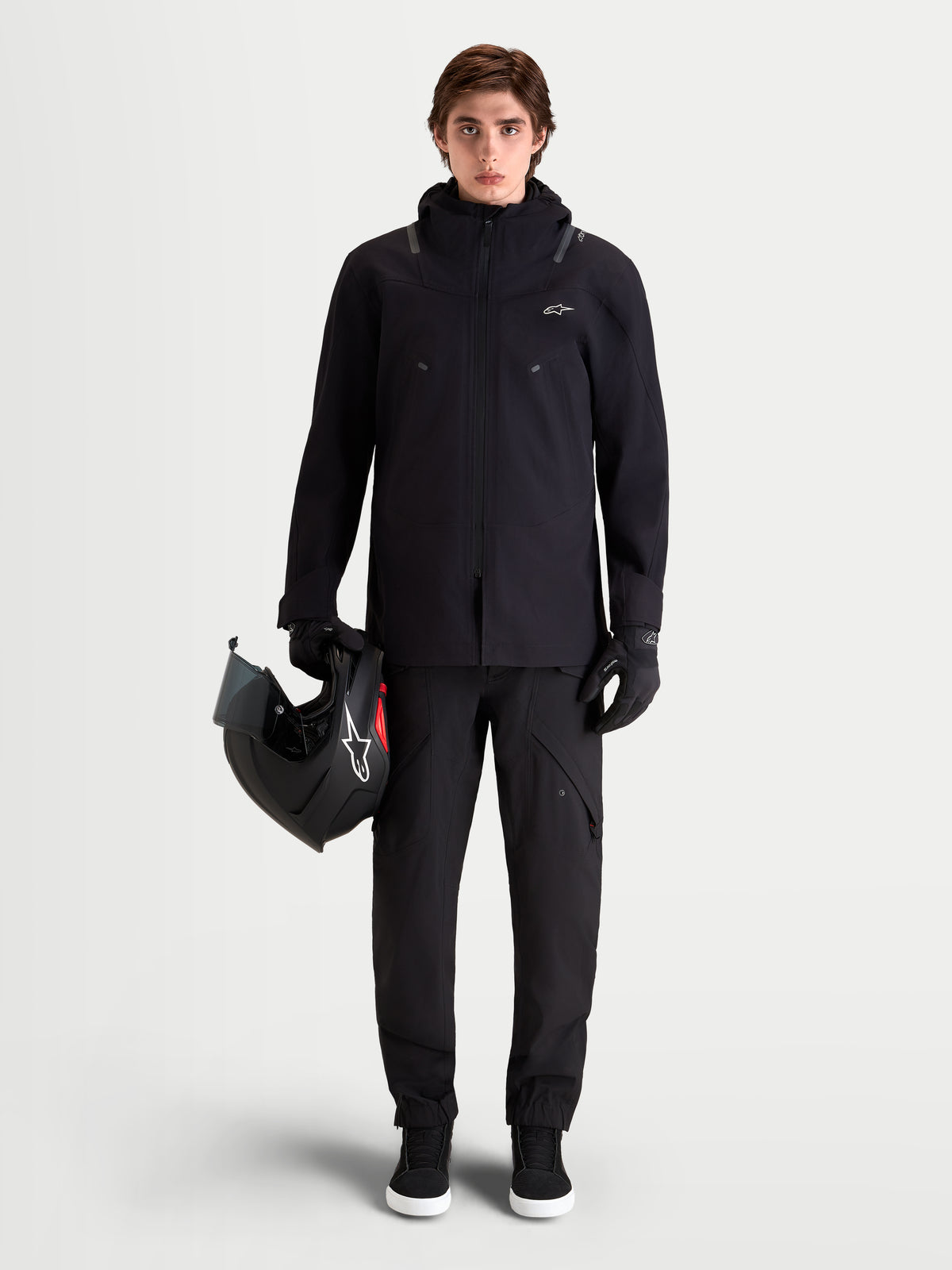 Alpinestars Juggernaut V2 Drystar Pants, men's urban contemporary motorcycle pants in black, full-length front view on a model wearing matching jacket and helmet, waterproof textile construction.