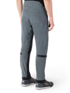 Alpinestars Alden Pants, Urban Gray, rear side view, streetwear-inspired technical riding pants with quilted detailing on the waist and black calf straps, paired with gray riding shoes, modern urban motorcycle gear