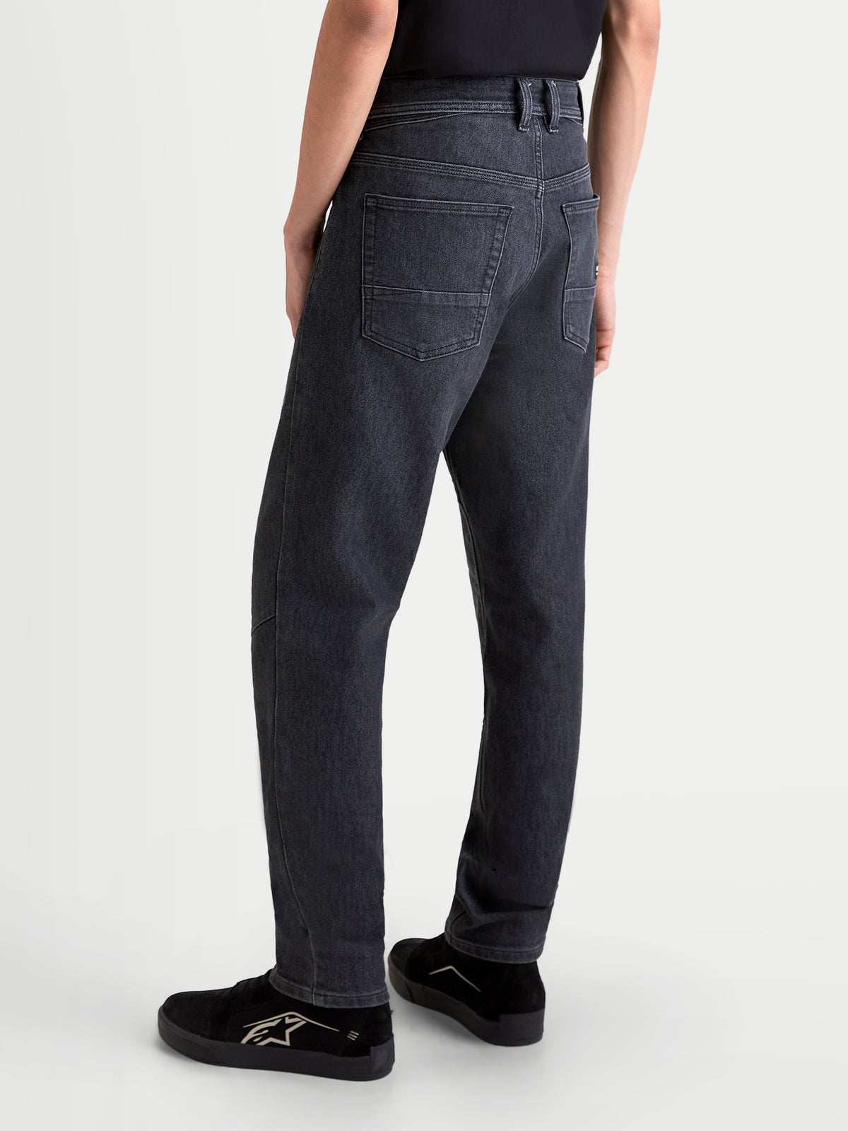 Alpinestars Flex-AST 7 Denim Pants, men's urban motorcycle riding jeans in faded black, rear view showing single-layer technical denim construction, five-pocket layout, and comfortable regular cut worn by a model.