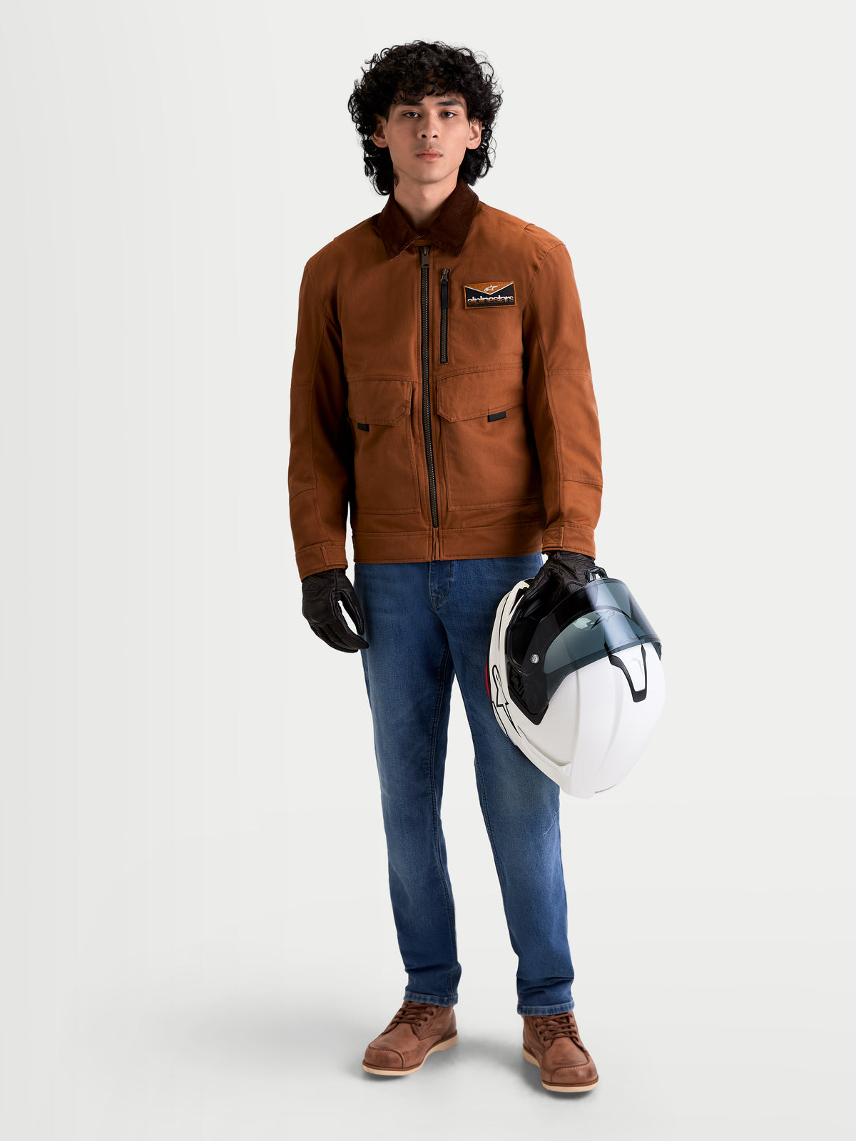 Alpinestars Flex-AST 7 Denim Pants, men's urban motorcycle riding jeans in light blue, worn by a model holding a helmet and matching jacket