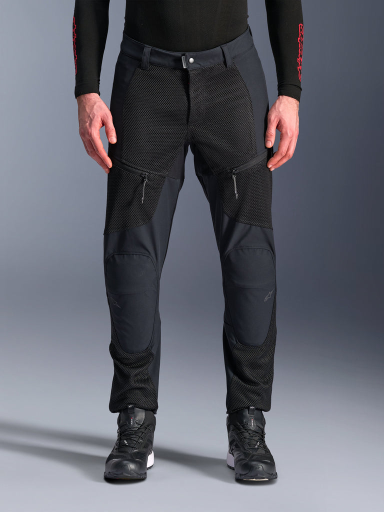 Alpinestars Troop-Air Pro Pants, Black Motorcycle Pants, featuring large mesh ventilation panels on the thighs and lower legs, zippered front pockets, sports fit textile design, worn with black riding shoes and a long-sleeve base layer
