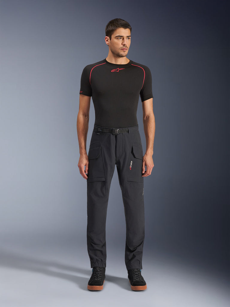 Alpinestars Juggernaut V2 Riding Pants, Motorcycle Pants, Dark Gray, Large Cargo Pockets, Belt Loops, Technical Riding Gear, Worn with Black Shirt with Red Accents