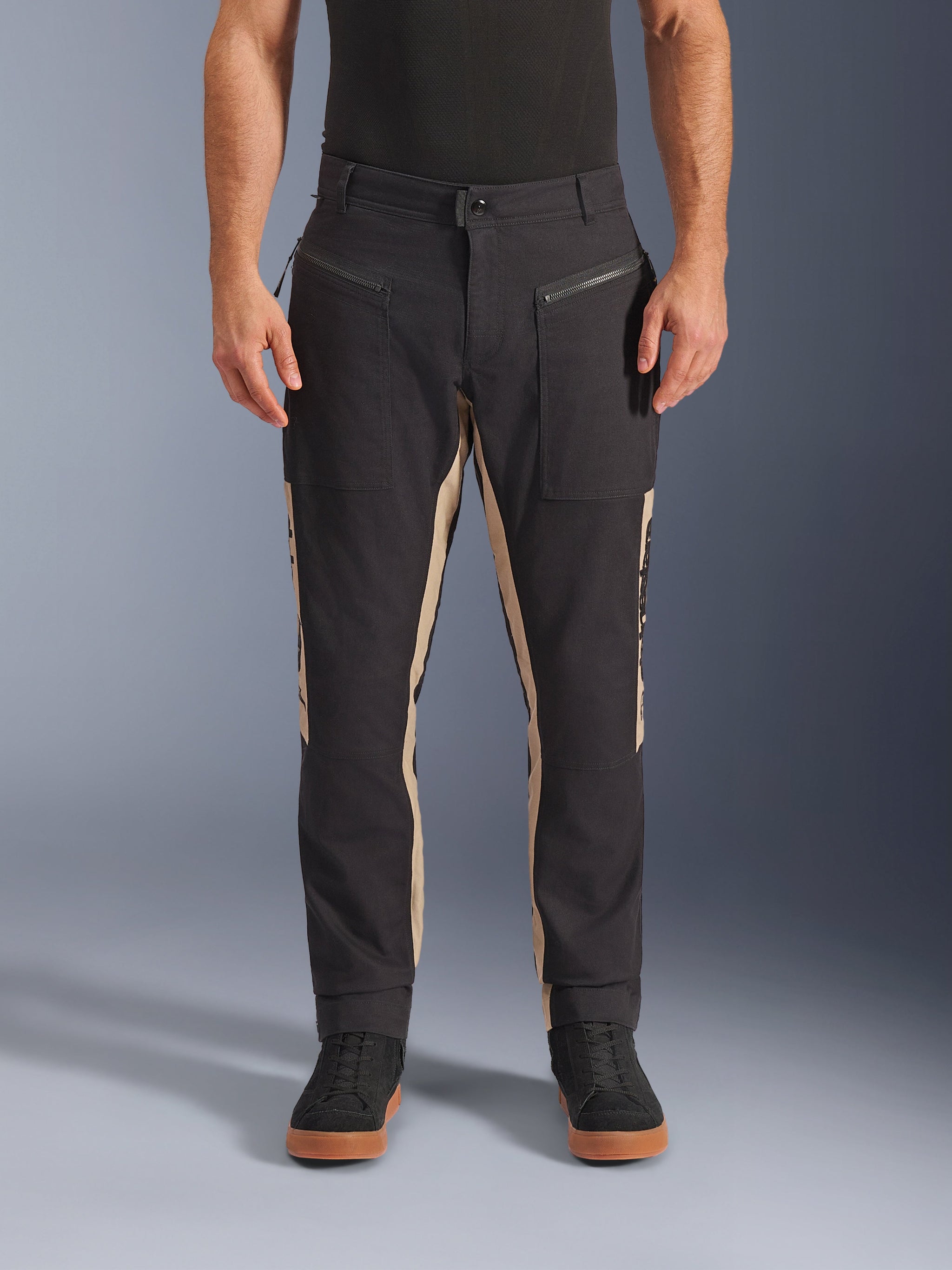 Alpinestars Flex-AST Canvas Pants, Urban Motorcycle Pants, Black and Aluminum, heritage-inspired workwear design, zippered front pockets, ergonomic moto cut, worn with casual black sneakers and black t-shirt, utilitarian street style