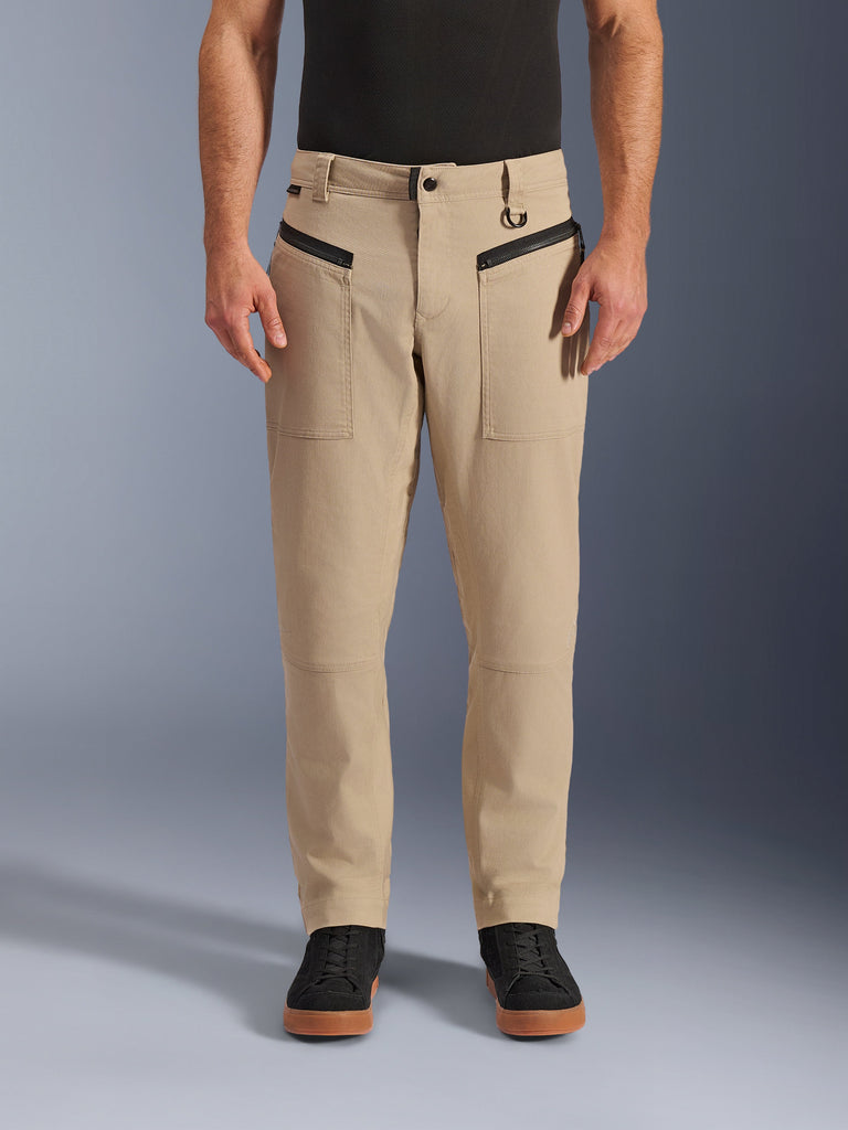Alpinestars Flex-AST Canvas Pants, Urban Motorcycle Pants, Brown, heritage workwear styling, featuring black horizontal zippered front pockets and belt loop D-ring, worn with black shirt and shoes, studio front view