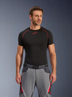 Alpinestars Maxdura Dual Pants, Dark Gray and Deep Gray with red accents, worn with a black base layer shirt featuring red stitching, athletic fit with integrated magnetic buckle belt, durable adventure motorcycle gear
