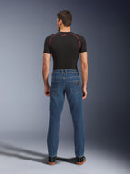 Alpinestars Flex-AST 5 Denim Pants, Indigo Washed blue, rear view showing tapered urban fit, worn by model with black performance t-shirt and sneakers, casual motorcycle protective wear