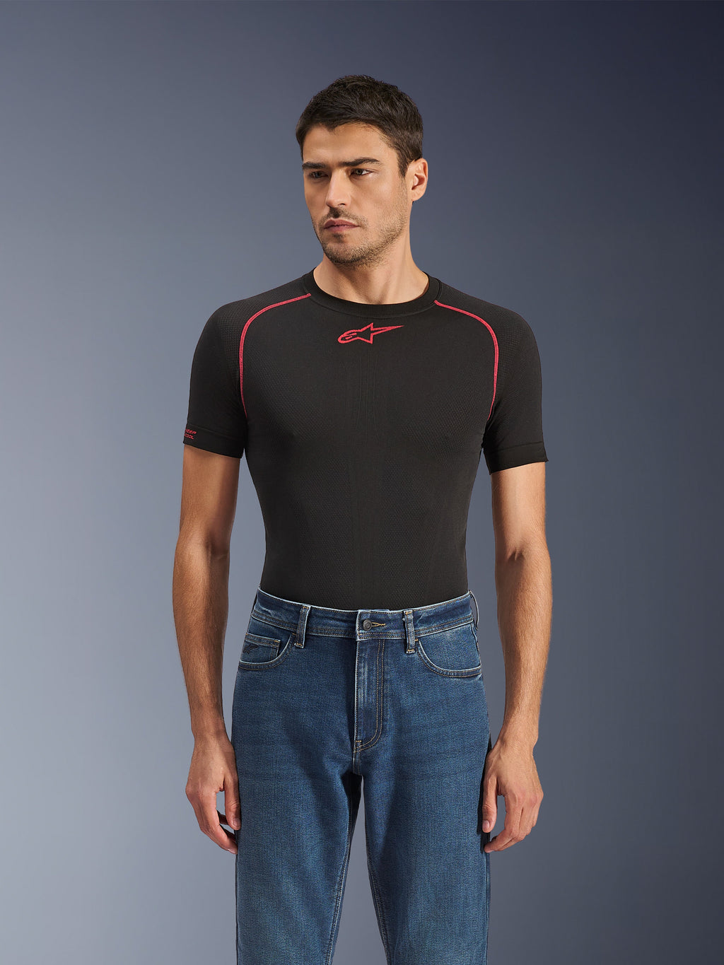 Alpinestars Flex-AST 5 Denim Pants in Indigo Washed, urban motorcycle jeans with a tapered fit, worn by a male model with a black short-sleeved base layer featuring red accents, casual road-to-street styling