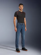 Alpinestars Flex-AST 5 Denim Pants - Short, Indigo Washed, urban motorcycle jeans with a tapered fit, worn by a male model with a black tight-fitting shirt and black sneakers, classic denim style for road-to-street transitions