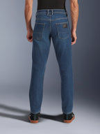 Alpinestars Flex-AST 5 Denim Pants, Men's Urban Motorcycle Jeans in Indigo Washed Blue, back view showing tapered fit, rear pockets with branded patch, and stretch denim construction.