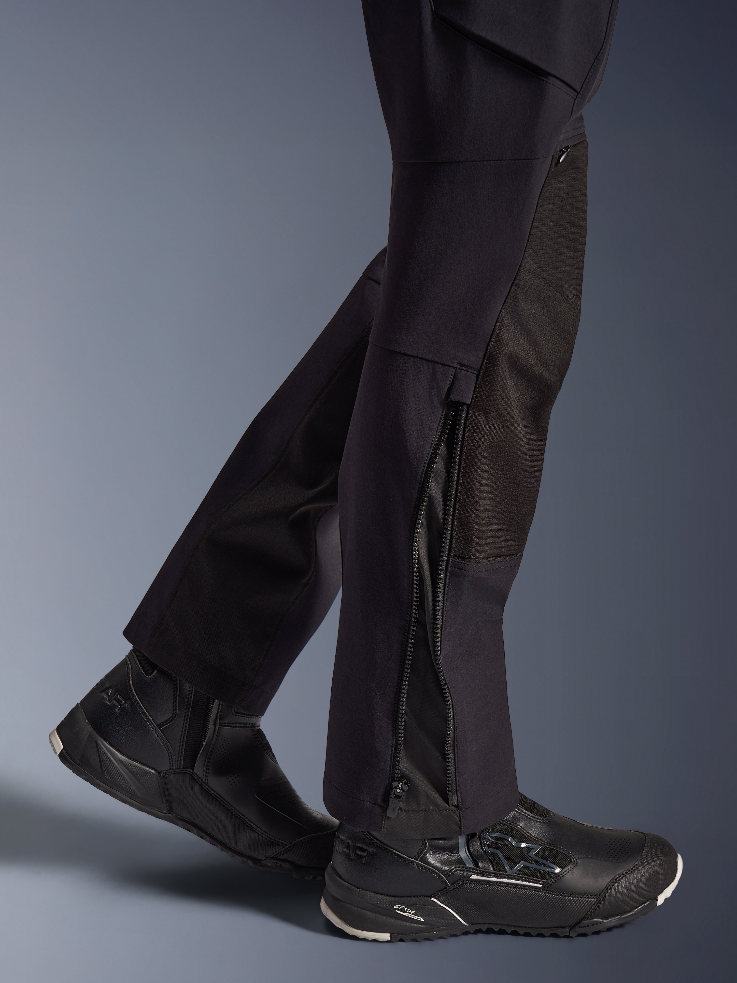 Alpinestars Stella Flex-AST Explorer Pants, Women's Motorcycle Pants, Black, close-up view of lower legs showing zippered leg hems and durable ripstop reinforcements, worn with black Alpinestars riding shoes