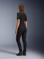 Alpinestars Womens Banshee Leggings, Black, rear view showing figure-hugging anatomical stretch fit and back pockets, worn with a black short-sleeved top and motorcycle boots, sleek urban motorcycle gear for women