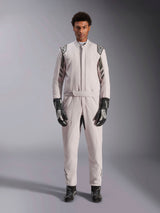 Alpinestars GP Race V3 Suit FIA in Silver Anthracite, one-piece auto racing suit worn by a model, featuring dark gray epaulettes and accents, paired with black racing gloves and boots, professional motorsport protective gear.
