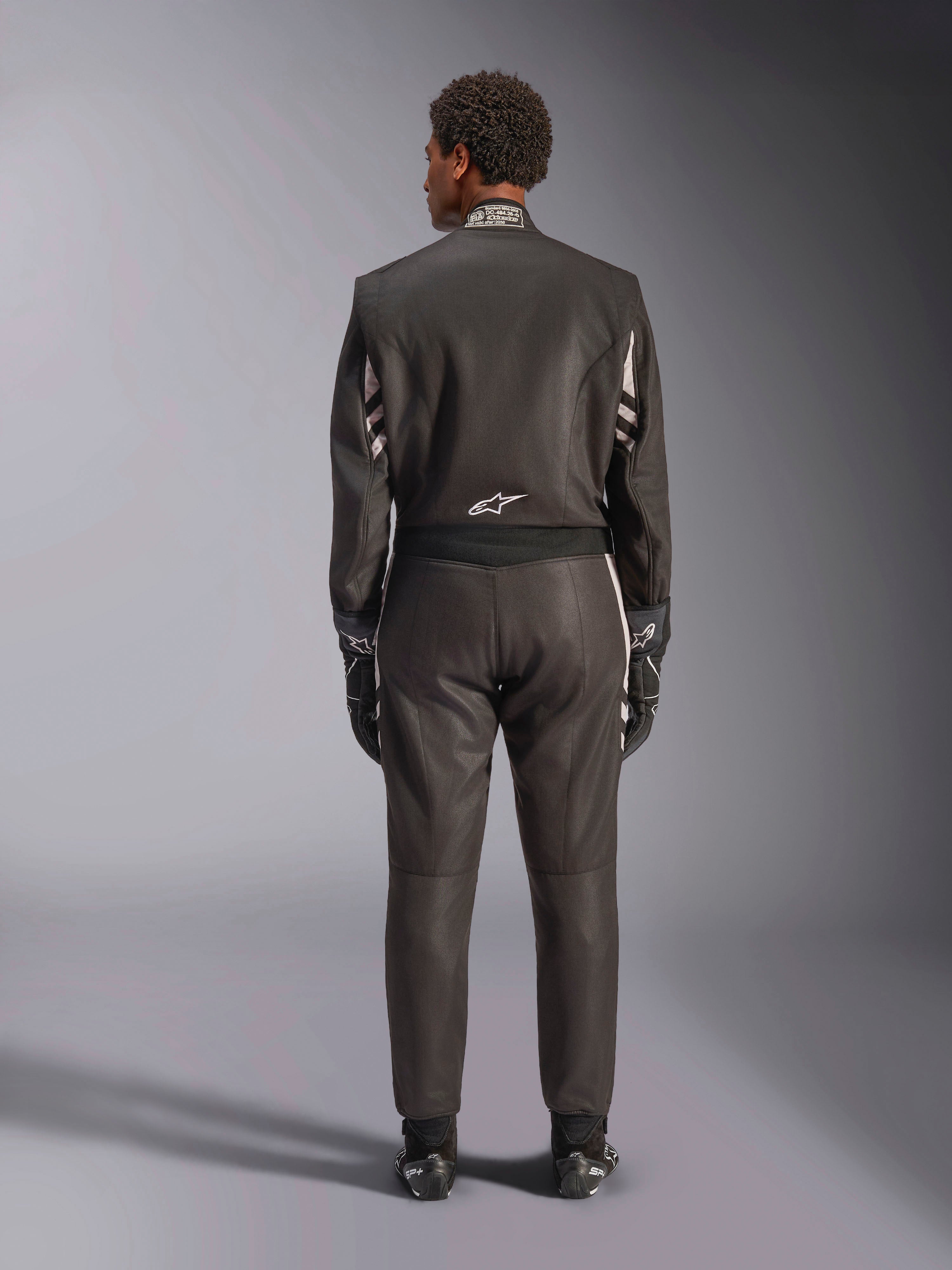 Alpinestars GP Race V3 Suit FIA, Rear View, Black and Silver, professional auto racing suit featuring two-layer aramidic construction and stretch panels, worn with matching racing gloves and boots