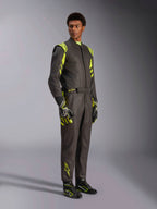 Alpinestars GP Race V3 Suit FIA, Auto Racing Suit, Black and Yellow Fluo, worn by a model with matching racing gloves and boots, featuring vibrant yellow accents on the shoulders and legs, professional motorsport gear