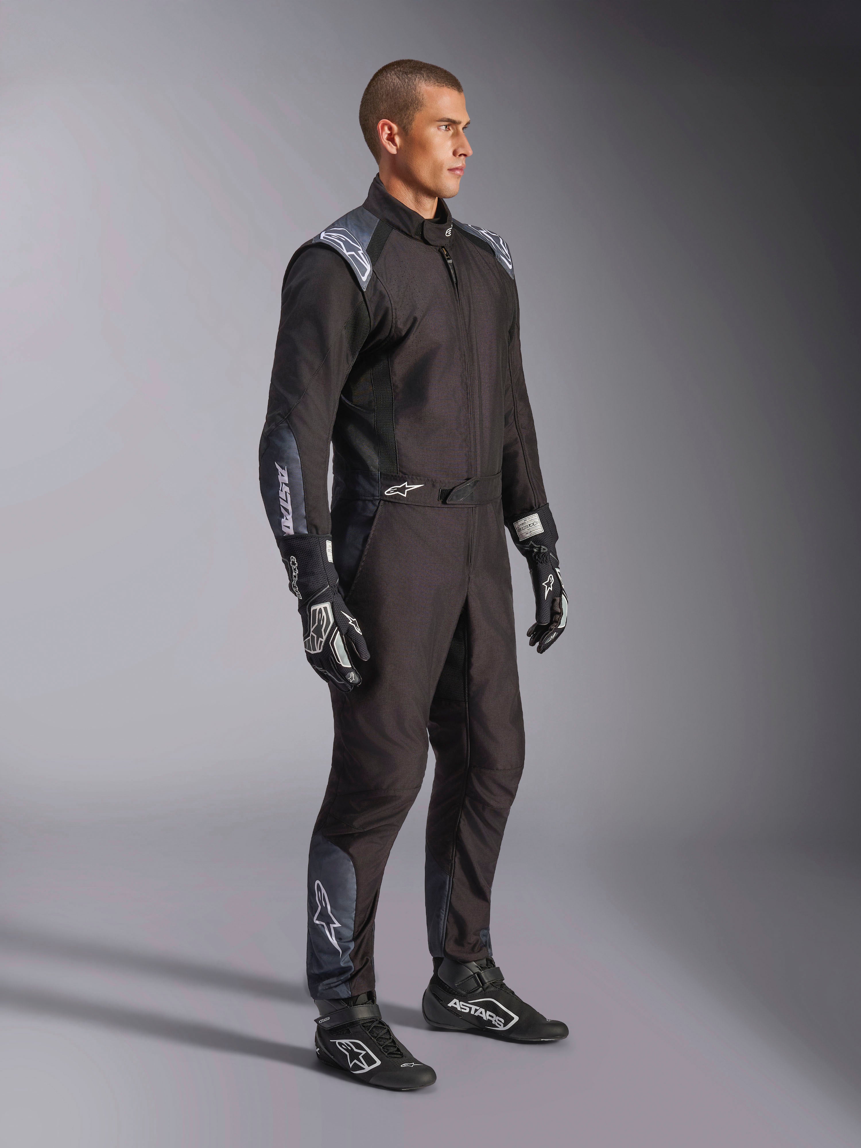 Alpinestars KMX-5 V3 Suit, Karting Suit in Black Dark Shadow, worn with matching black racing gloves and shoes, featuring laser-cut perforations and tech mesh panels, sleek dual-layer design with white branding for professional motorsport