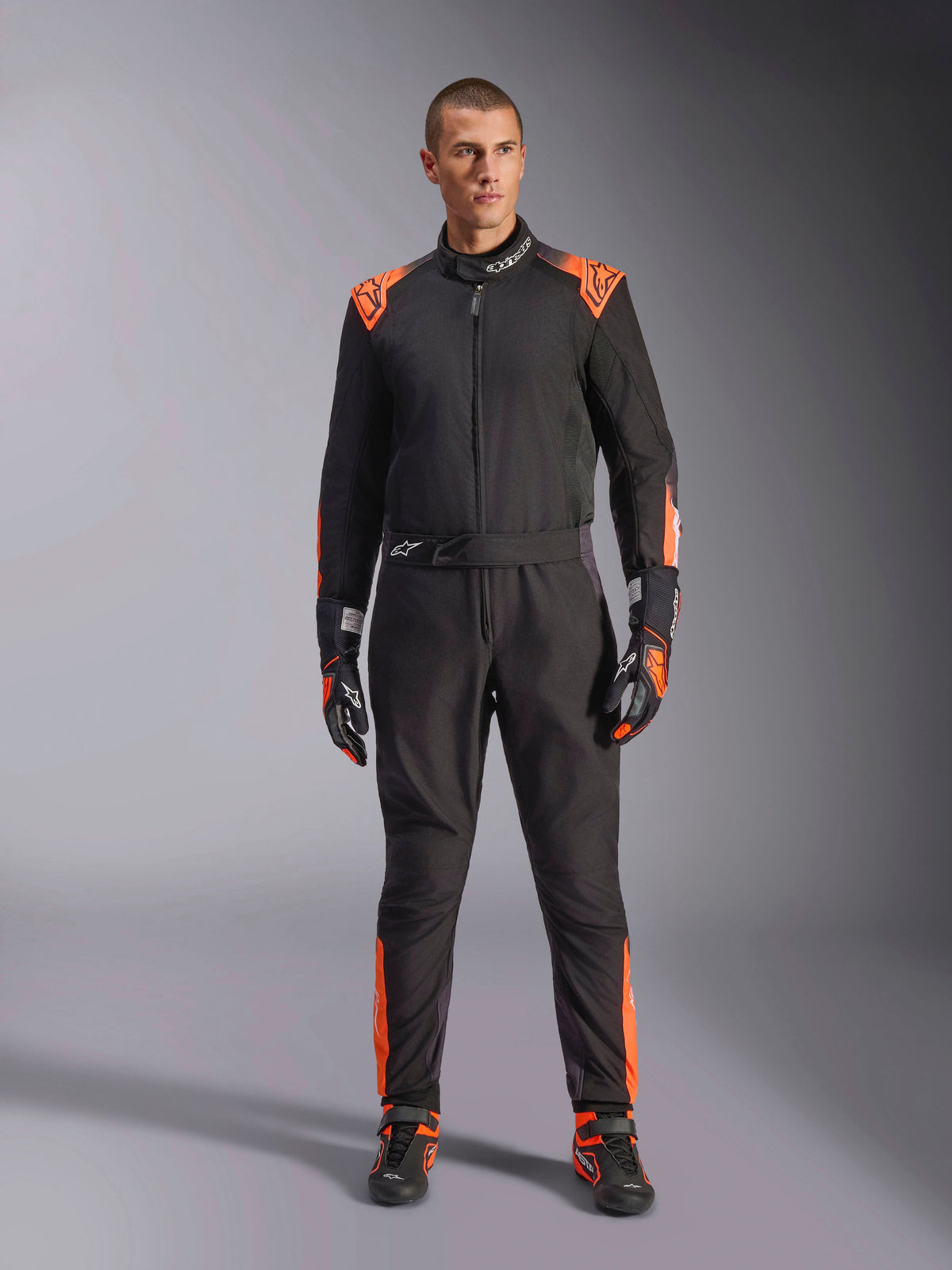 Alpinestars KMX-5 V3 Suit, Men's Karting One-Piece, Black and Orange Fluo, FIA 8877-2022 Grade 1 certified racing gear.