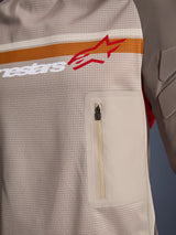 Alpinestars Maxdura Dual Jersey, Aluminum Walnut, close-up detail of the mesh torso, horizontal orange and white stripe with red logo, vertical zippered chest pocket, adventure motorcycle apparel