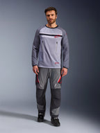 Alpinestars Maxdura Dual Jersey, Mid Gray and Dark Gray, adventure motorcycle jersey with mesh torso and zippered chest pockets, abrasion-resistant sleeves with integrated padding, worn with matching gray performance pants with red accents, technical off-road riding gear