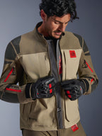 Alpinestars Nazca 3L GORE-TEX PRO Jacket, Walnut Rock Brown, adventure motorcycle jacket with unzipped front revealing central mesh airflow panel, red All Terra branding, worn with black GORE-TEX riding gloves, technical gear for off-road touring