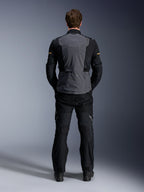Alpinestars ST-7 2L GORE-TEX Jacket, Deep Gray Black and Dark Khaki, rear view on a model, adventure motorcycle touring jacket with gray back panel and black articulated sleeves, worn with matching black pants.