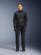 Alpinestars Stella ST-7 2L GORE-TEX Jacket, Women's Motorcycle Touring Jacket, Black and Dark Gray, worn with matching riding pants and gloves, featuring waterproof laminated shell, reflective accents, and ergonomic adventure design