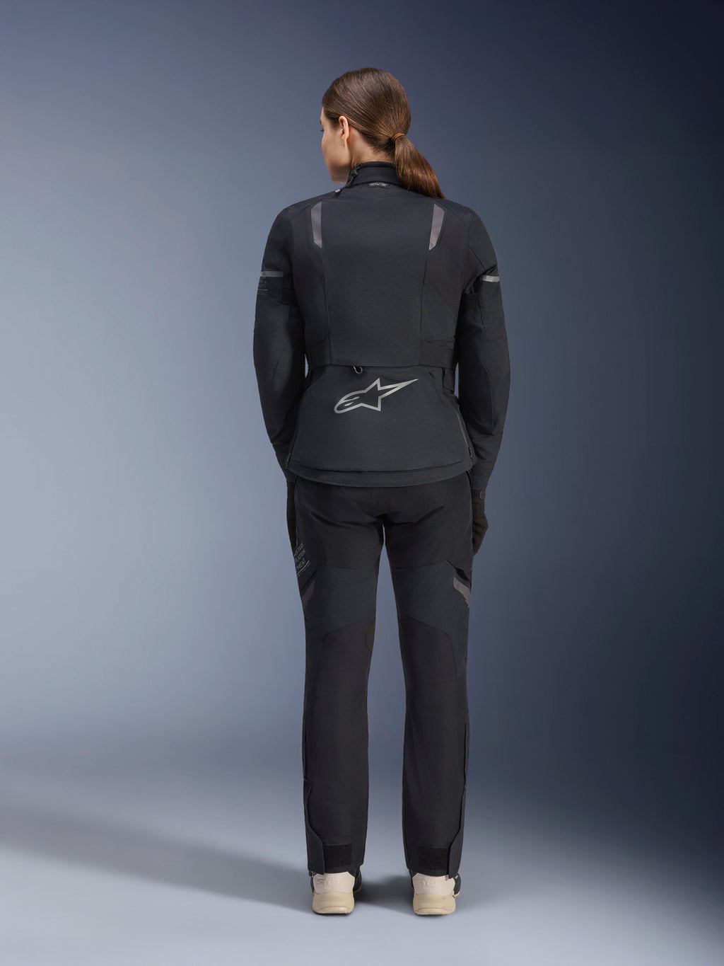 Alpinestars Stella ST-7 2L GORE-TEX Jacket and Pants, Women's Motorcycle Adventure Touring outfit, Black and Dark Gray, back view showing the Astar logo and reflective details, durable waterproof textile construction