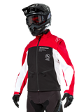 Alpinestars Lite-Dura Softshell Jacket, Motorcycle Jacket, Black, Bright Red, and White, worn by a rider with a black motocross helmet, red goggles, and gloves, featuring bold branding on the chest, designed for off-road and enduro riding