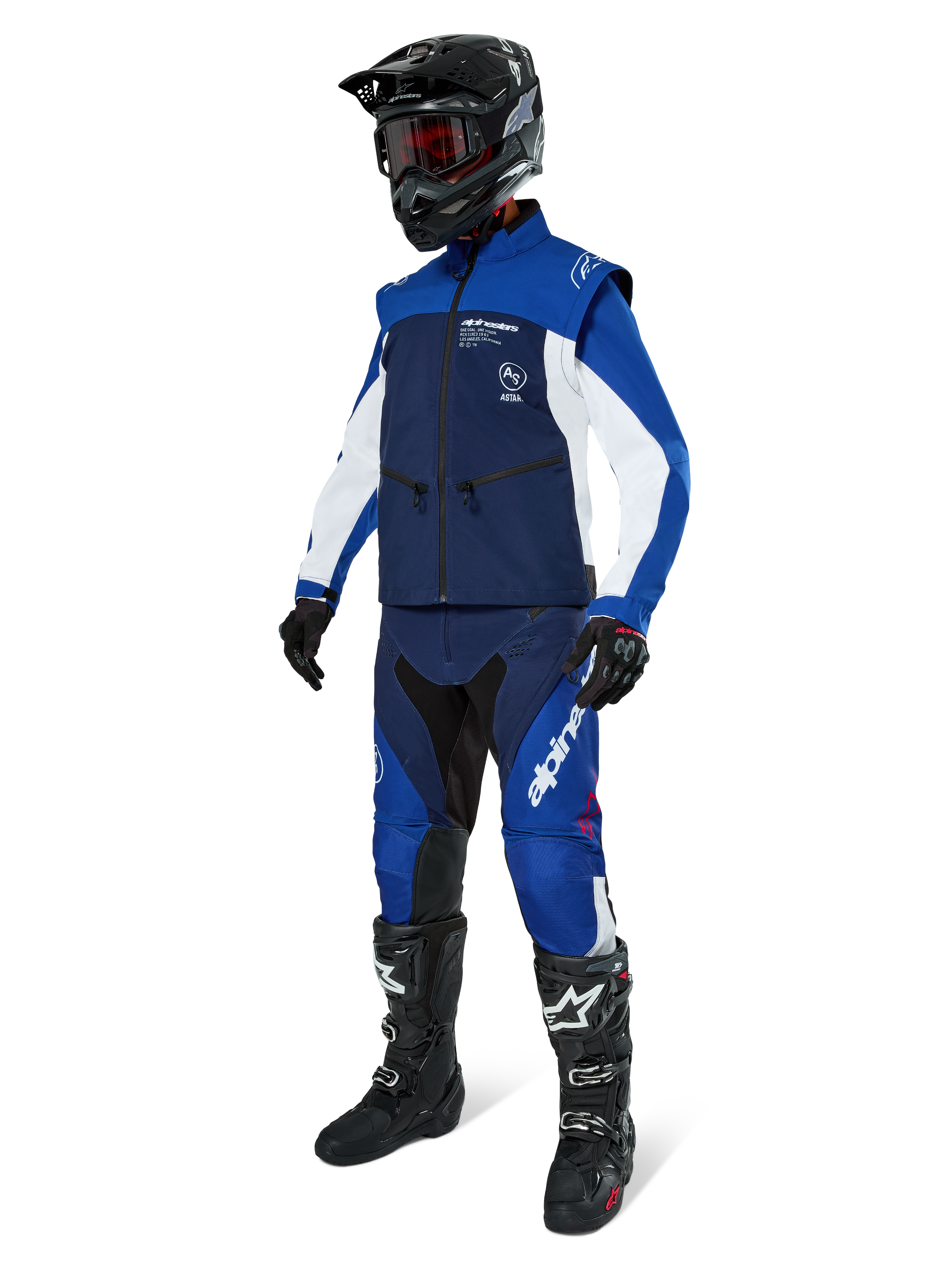 Alpinestars Lite-Dura Softshell Jacket, Navy Bright Blue and White, worn with matching off-road pants, black motocross boots, black helmet with goggles, and black gloves, complete enduro gear for off-road racing