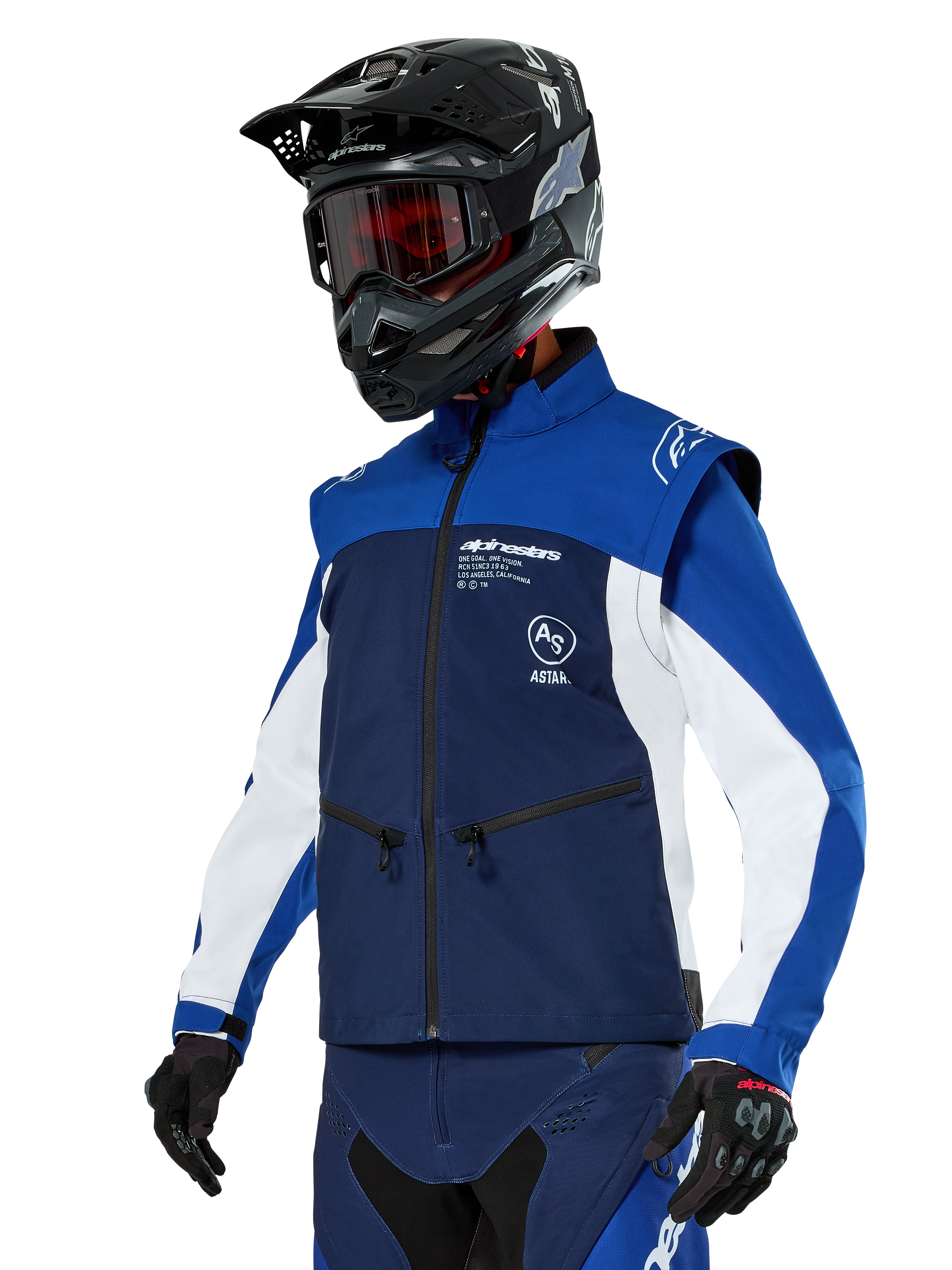 Alpinestars Lite-Dura Softshell Jacket, Navy, Bright Blue and White, Off-Road Enduro Jacket, worn with black helmet and red-tinted goggles, sporty color-block design with multiple zippers and brand logos, durable textile for motocross and trail riding