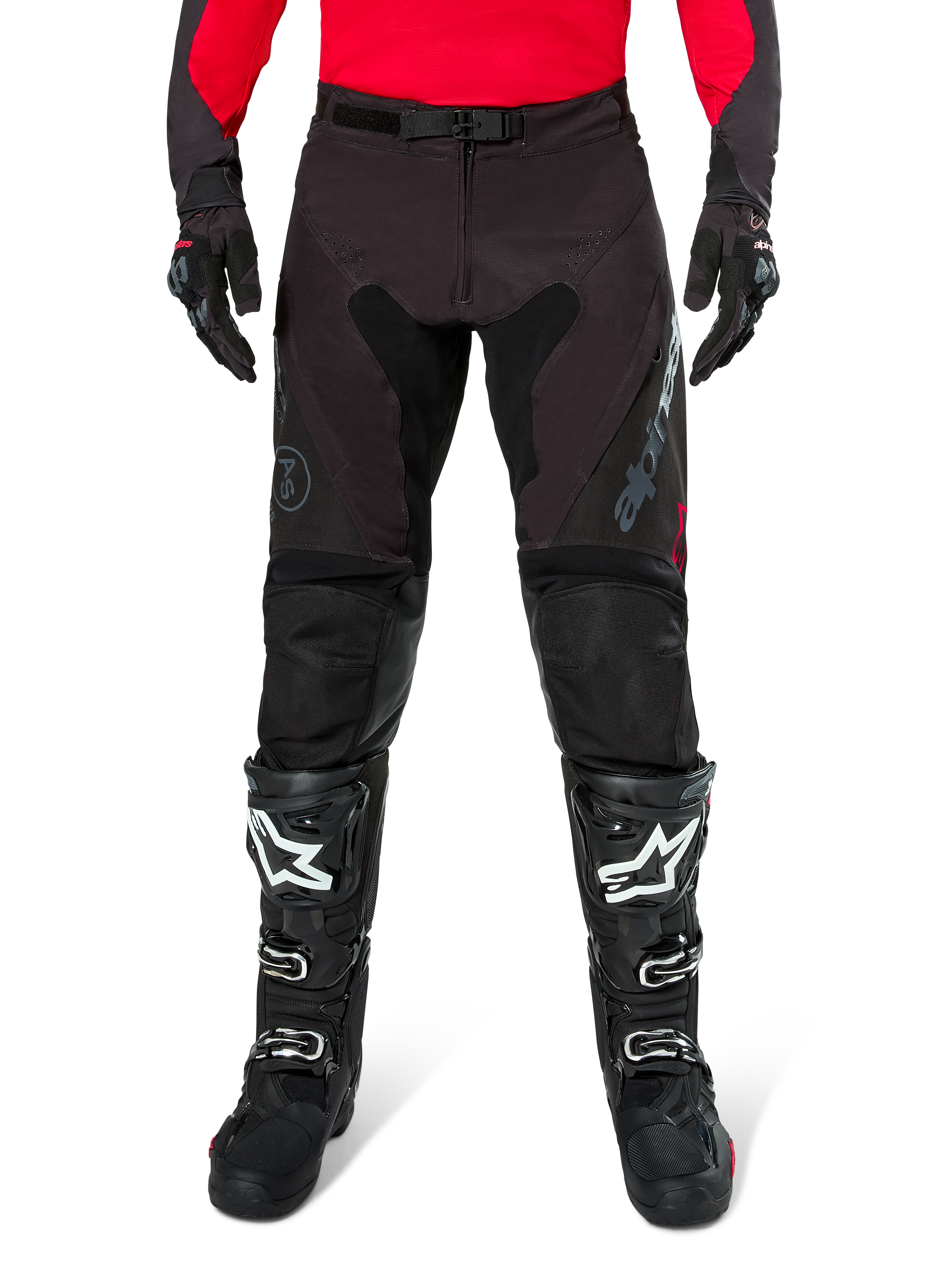 Alpinestars Pro-Dura Pants, Black and Magnet Enduro Pants, worn with a red long-sleeve jersey and black motocross boots, featuring gray Alpinestars branding and durable ripstop construction for off-road riding