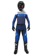 Alpinestars Pro-Dura Pants, Motocross and Enduro Pants, Navy Bright Blue and White, worn by a rider in a complete racing kit with a matching jersey, black helmet, red goggles, and black boots, professional off-road gear setup