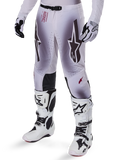 Alpinestars 2025 Supertech Maker Pants, Motocross Racing Pants, Silver and Black, featuring large star logos and red lettering, shown with matching white boots and gloves