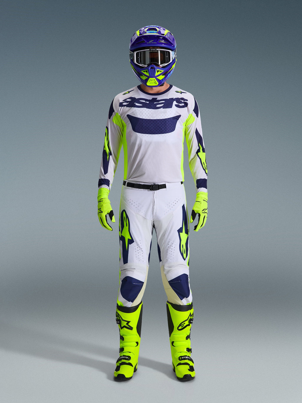 Alpinestars 2026 Racer Air Riway Gear Set, Motocross racing gear, white jersey with blue logo and fluo yellow accents, white pants with blue and yellow patterns, purple and yellow helmet, fluo yellow boots and gloves, complete off-road kit