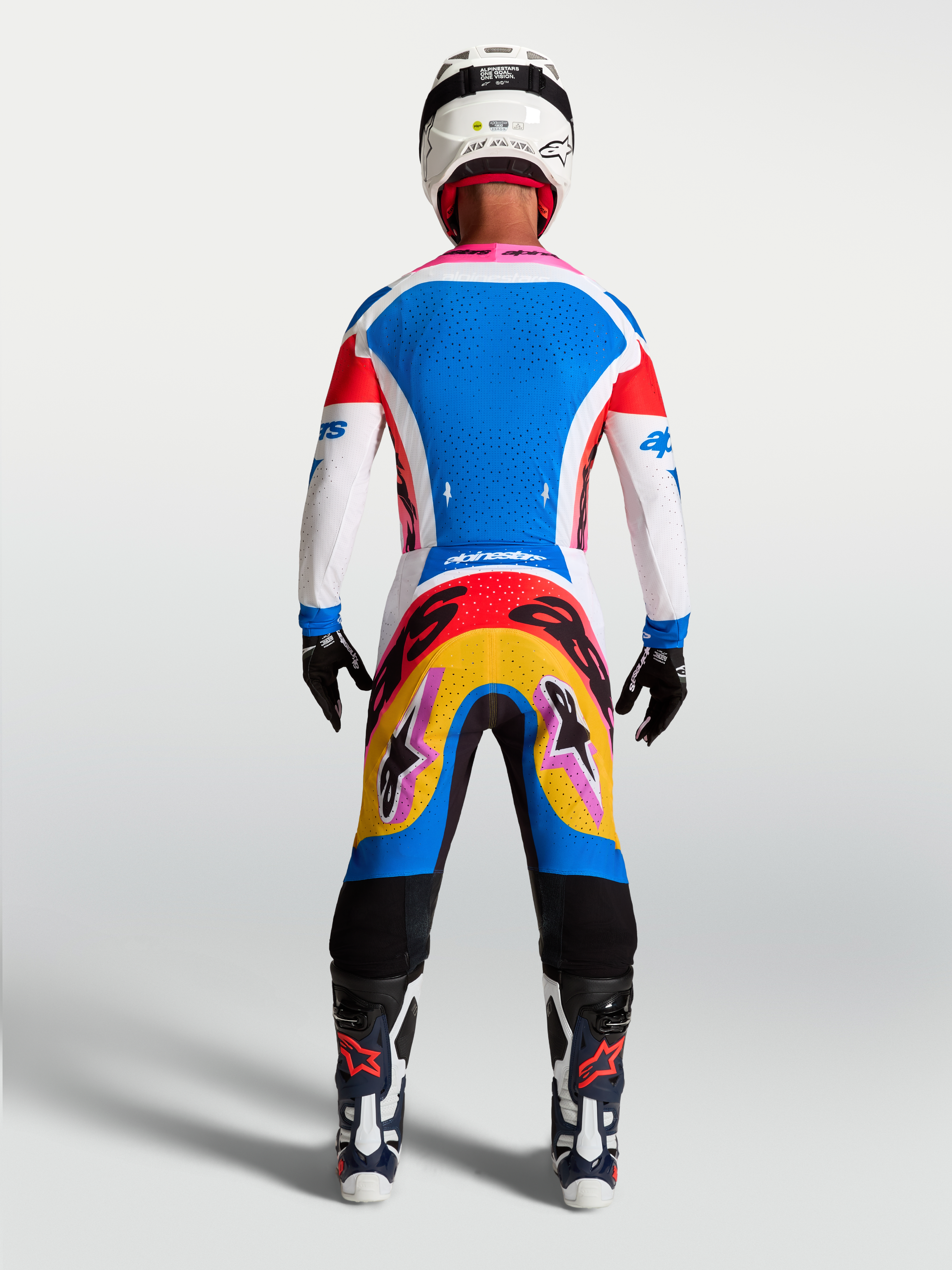 Alpinestars Supertech Dyna Motocross Gear Set, men's blue and white jersey and pants with vibrant graphics, rear on-model view.